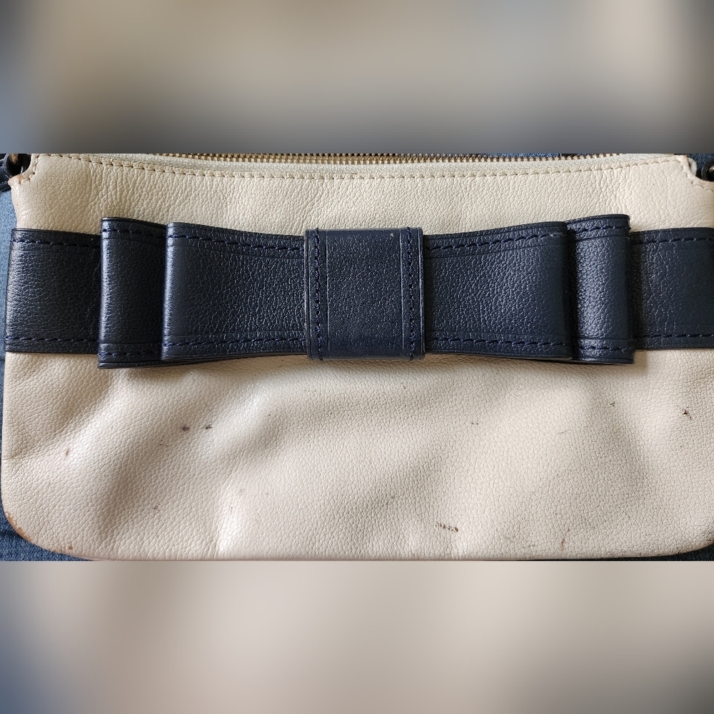 Well loved Kate Spade cream and blue clutch